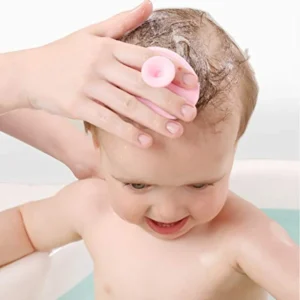 massing the baby's head with gentle scrubber