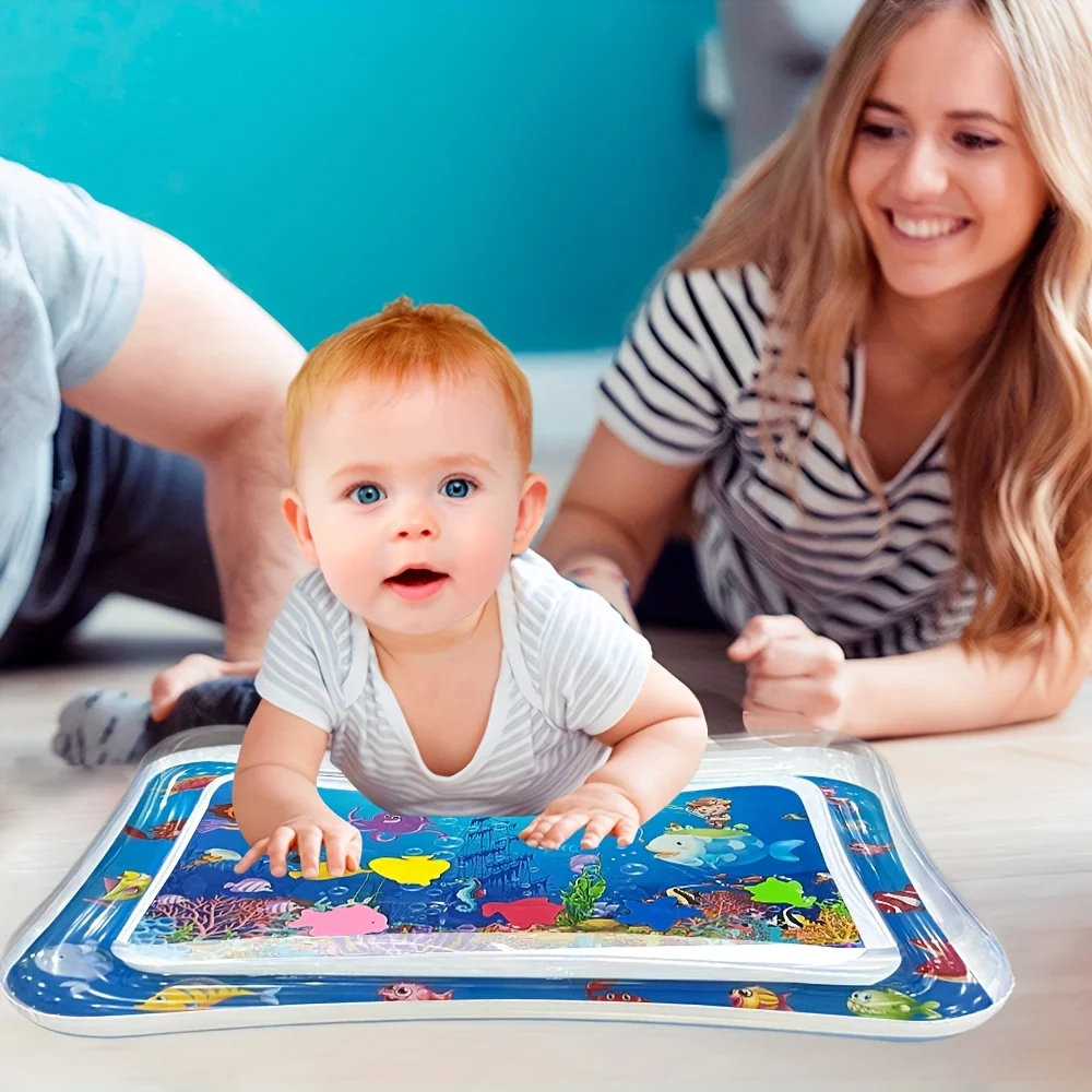 baby looks happy on tummy water pad