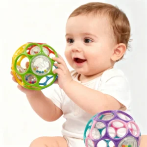 baby is holding a soft, flexible ball with a chime